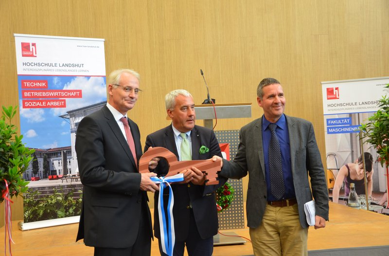 President of the University, Prof. Dr. Karl Stoffel, together with Dr. Ludwig Spaenle, Member of the State Assembly, accepted the symbolic key to the new building from the head of the State Construction Authority for Landshut, Reinhard Piper (l to r).