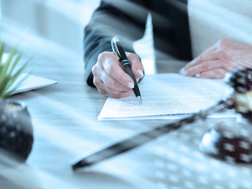 Female lawyer working on document; light effect